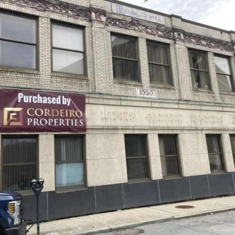 Cordeiro Properties banner displayed on a brick building, marked with the year 1930.