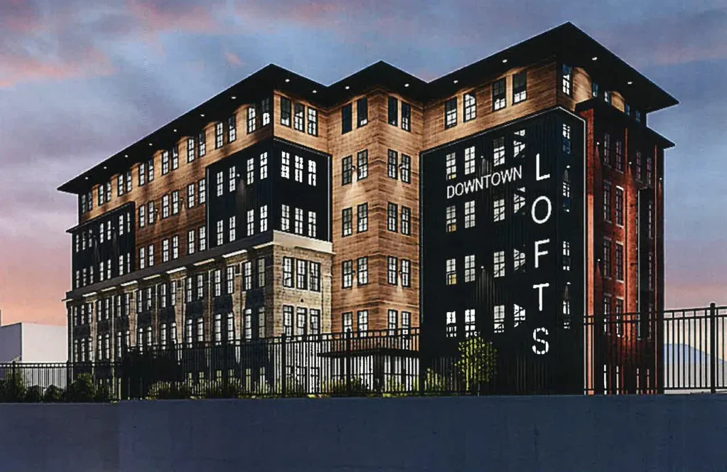 Modern loft building with "Downtown Lofts" signage, featuring a mix of architectural styles and multiple windows.
