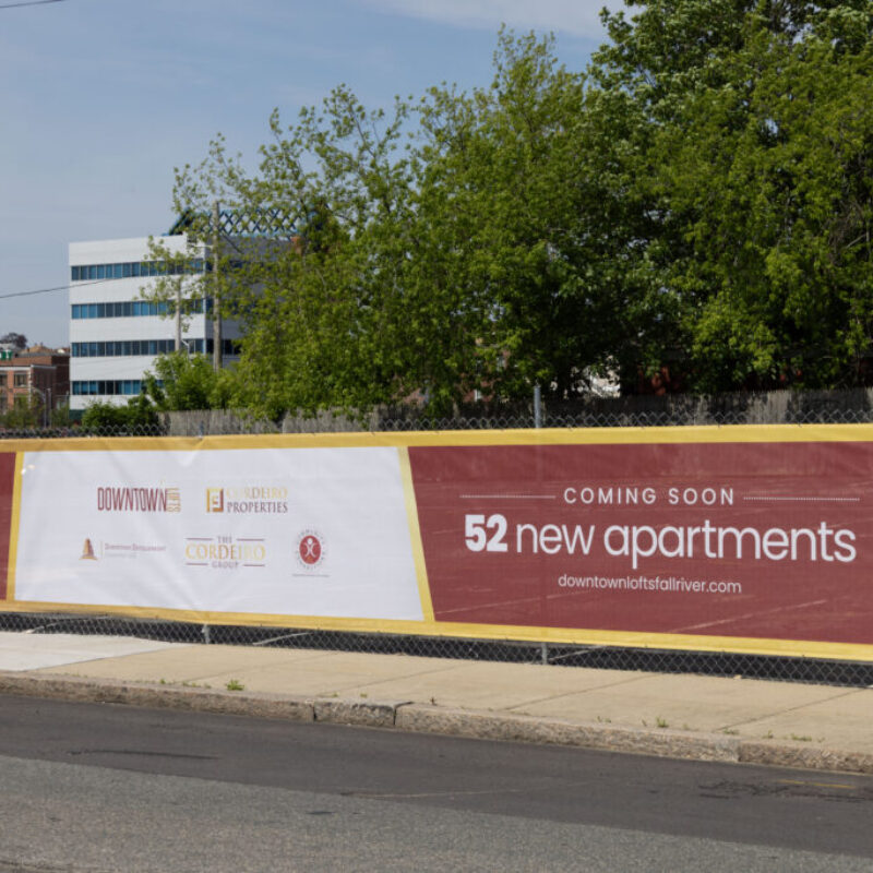 Banner announcing 52 new apartments coming soon, with logos of developers and a website link.