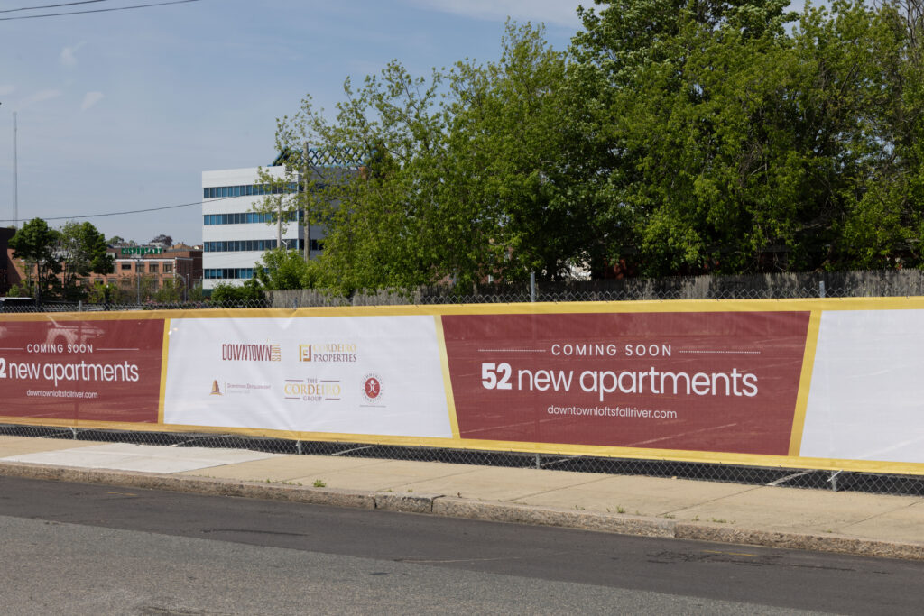 Banner announcing 52 new apartments coming soon, with logos of developers and a website link.