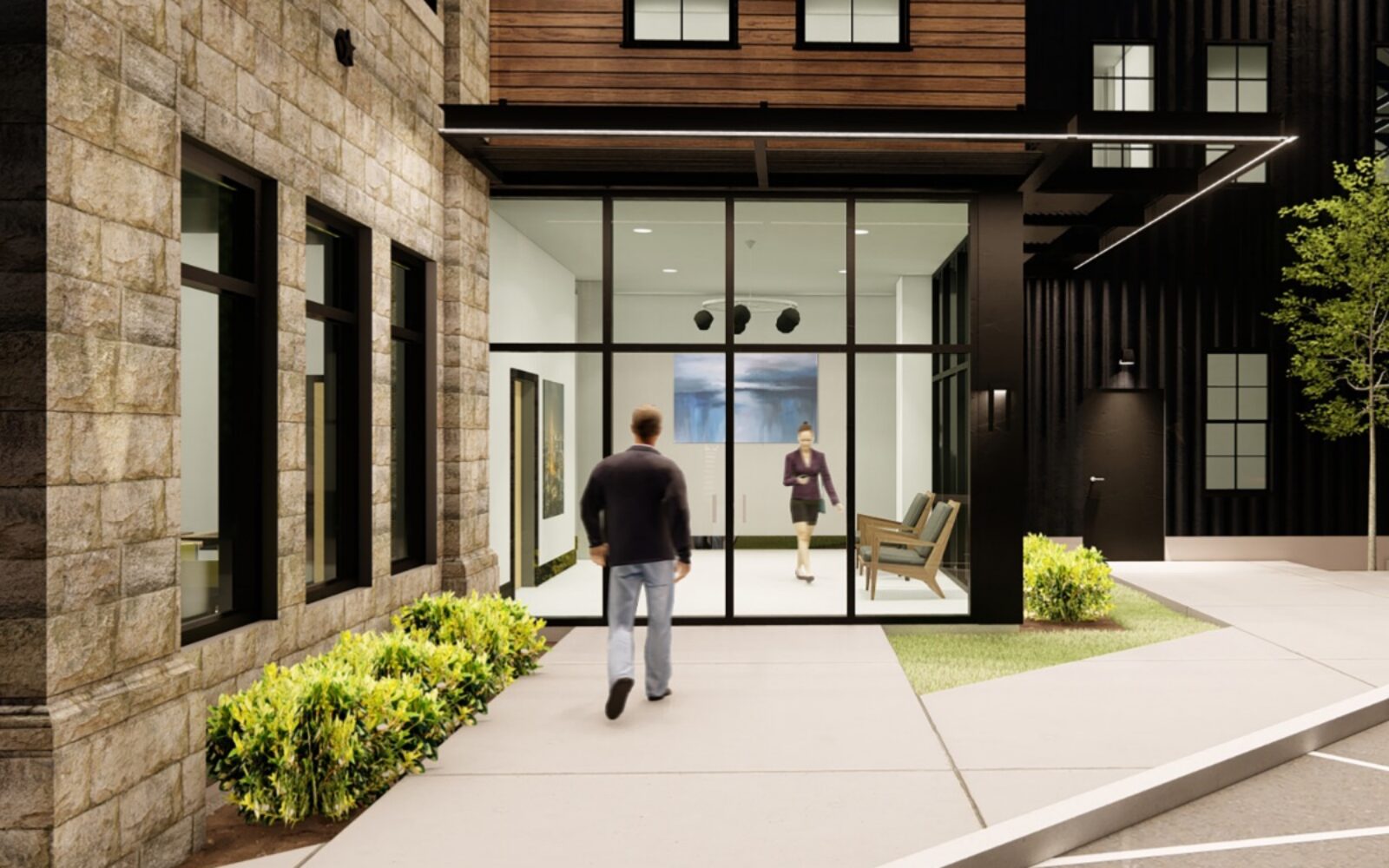 Two people approach a modern entrance with large glass doors and greenery. One person walks inside.