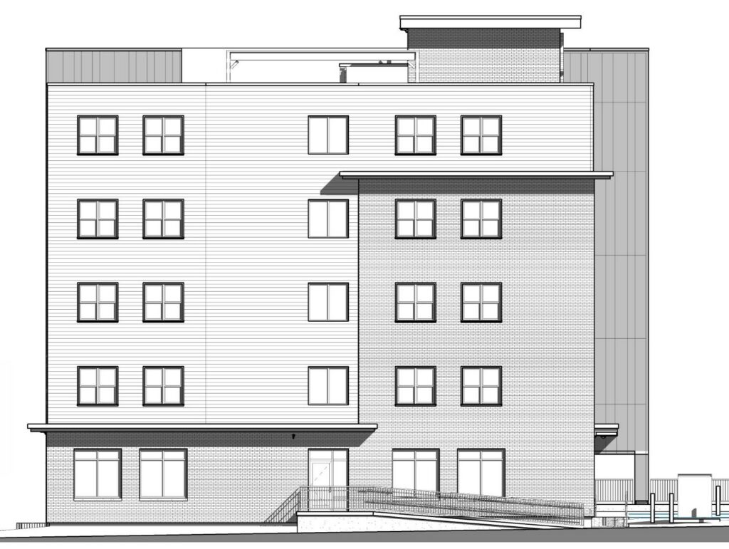 Five-story building with a mix of brick and siding, featuring multiple windows and a ramped entrance.