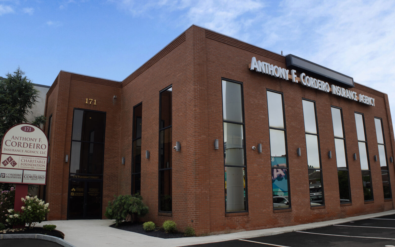 Brick building with large windows, featuring a sign for Anthony F. Cordeiro Insurance Agency.