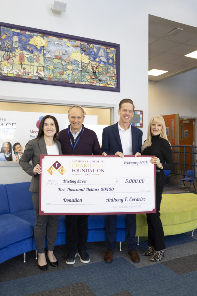 Four people hold a large check for $5,000 from the Anthony F. Cordeiro Charitable Foundation.