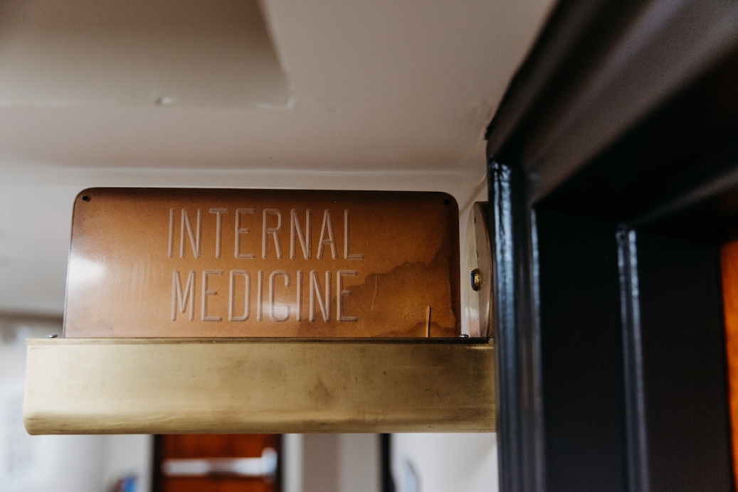 Sign for "Internal Medicine" mounted above a door in a medical facility.