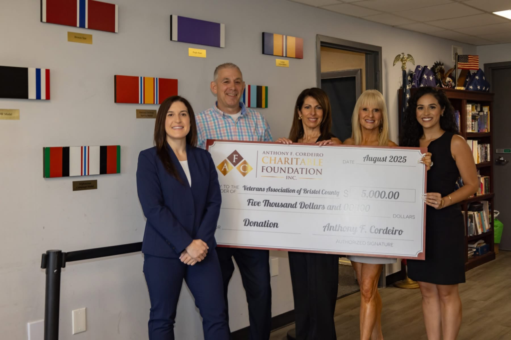 Four individuals hold a large check for $5,000, donating to the Veterans Association of Bristol County.
